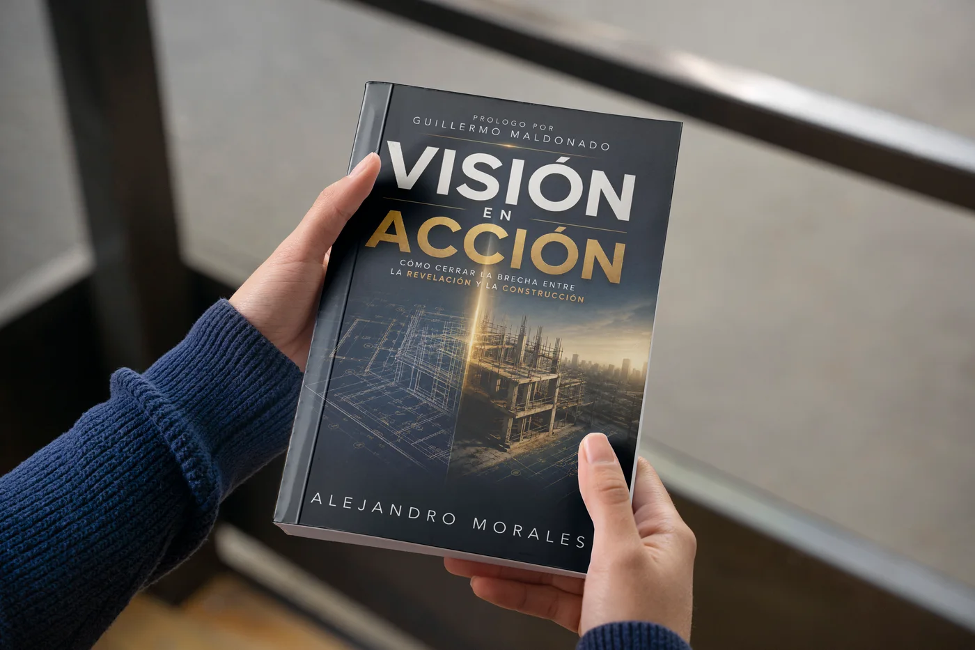 A person holding La Visión en Acción